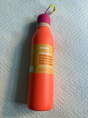 Owala Insulated Water Bottle in Coral with Pink Cap